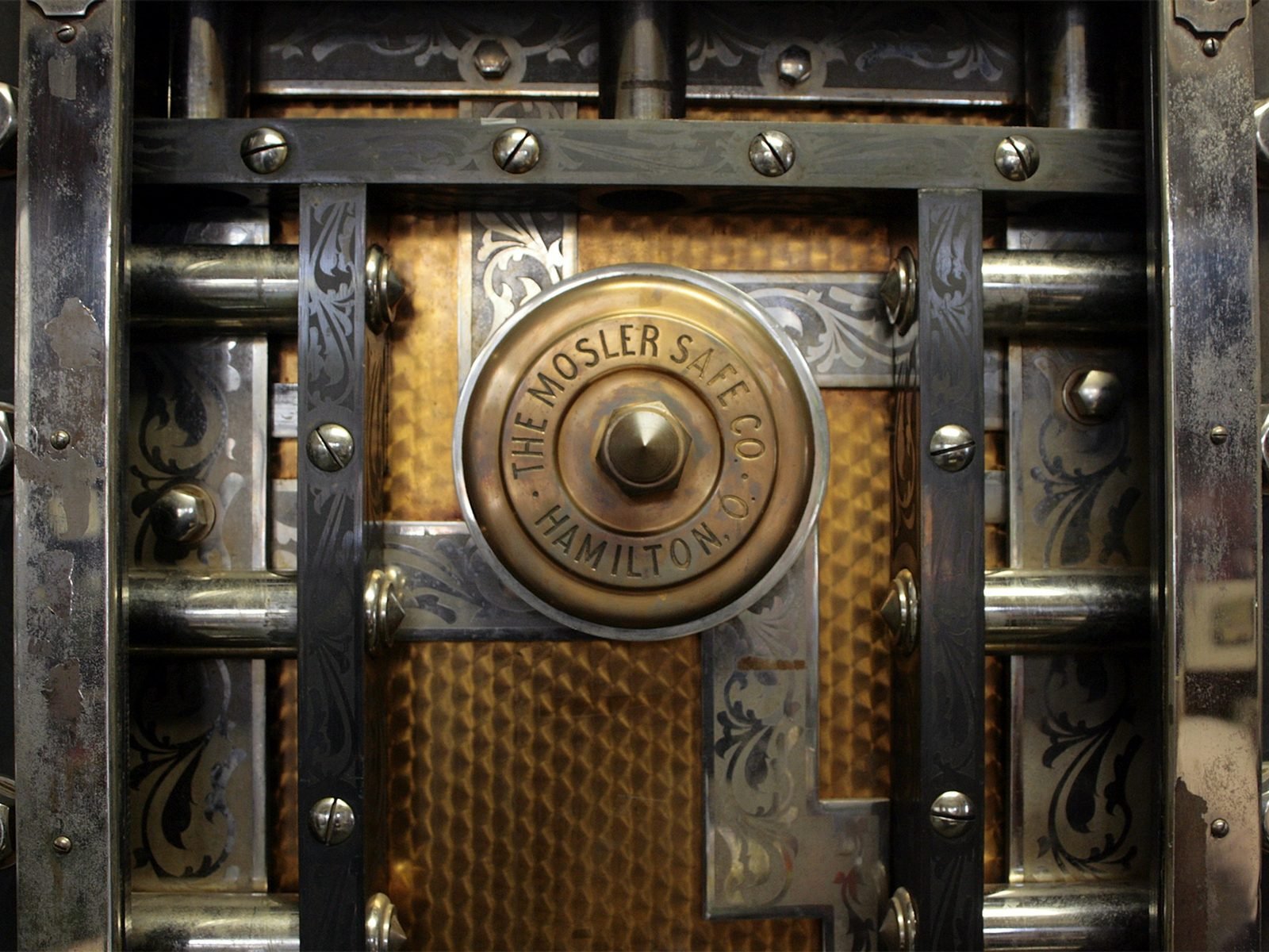 The brass dial and door of an antique Mosler safe